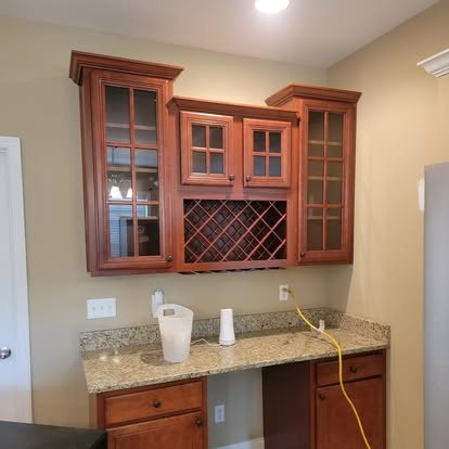 Before: dark cherry wood bar cabinets and tan walls