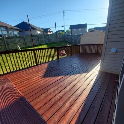 After: deck cleaned and stained a warm red-brown