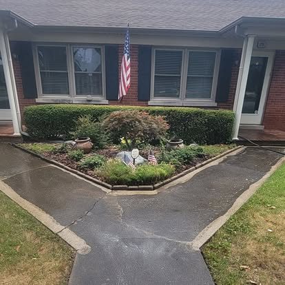 Before: dark, stained concrete walkway in front of a brick home